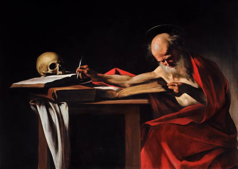 Caravaggio’s Saint Jerome Writing: the aged saint, draped in red, reaches his pen toward an open book beside a skull.